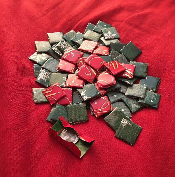 Small wrapped squares of weird Christmas gifts on a red cloth, featuring bizarre items received as holiday presents.