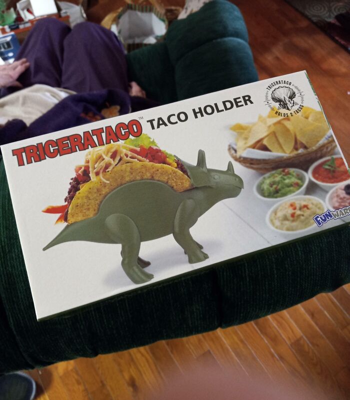Tricerataco taco holder shaped like a dinosaur holding tacos, one of the most bizarre Christmas gifts people received.