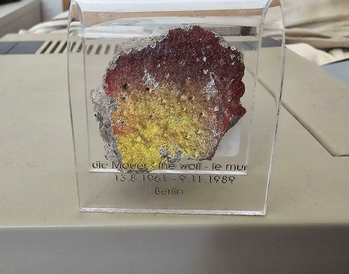 Fragment of the Berlin Wall encased in clear plastic, a bizarre Christmas gift received by a person.