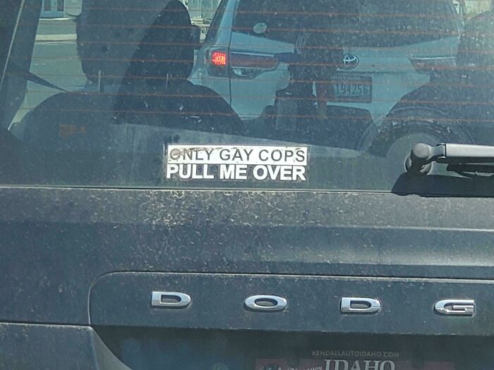 Sticker on a Dodge car rear window saying only gay cops pull me over, illustrating funny pictures from 2025 weirdness.