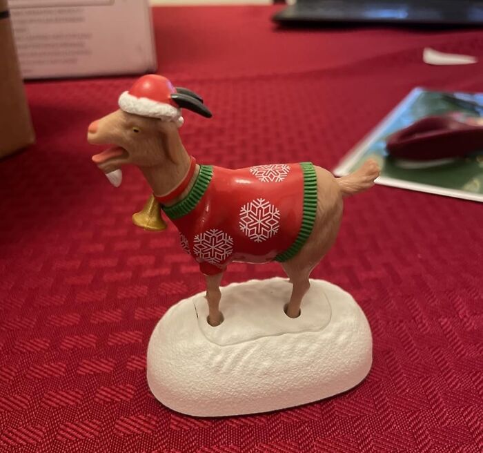 Festive goat figurine wearing a Christmas sweater and Santa hat, featured among 25 best sellers in 2025 delusional trends.