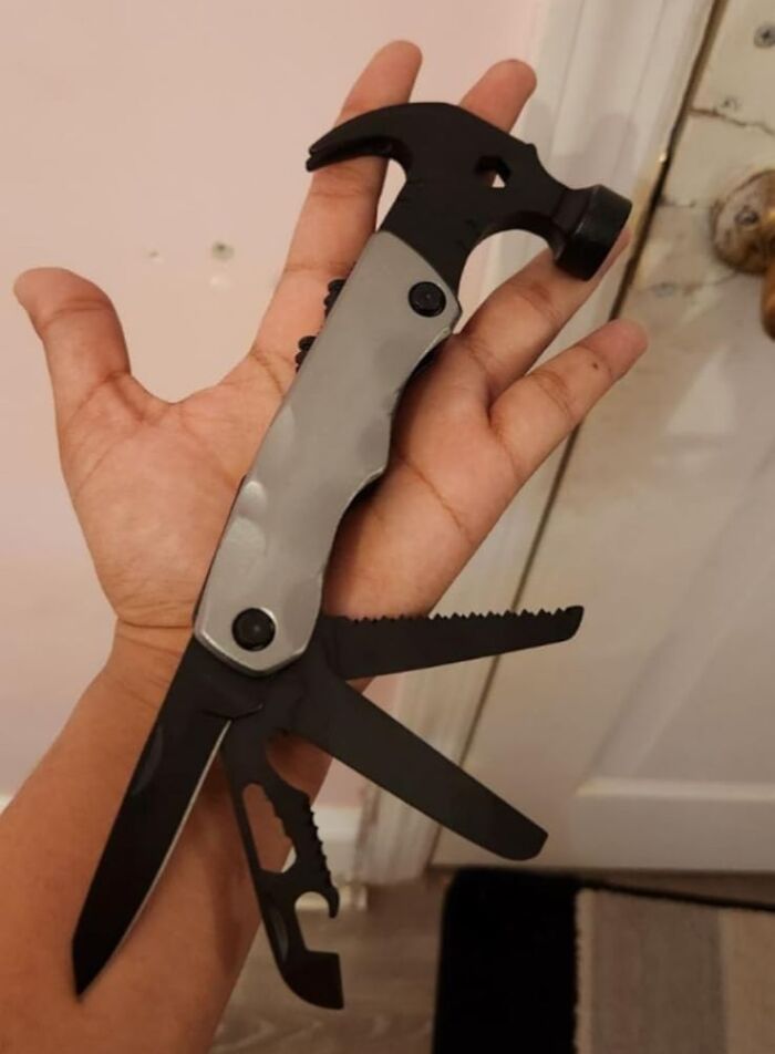 Multitool with hammer, knife, and saw attachments held in hand, showcasing popular best sellers in 2025.