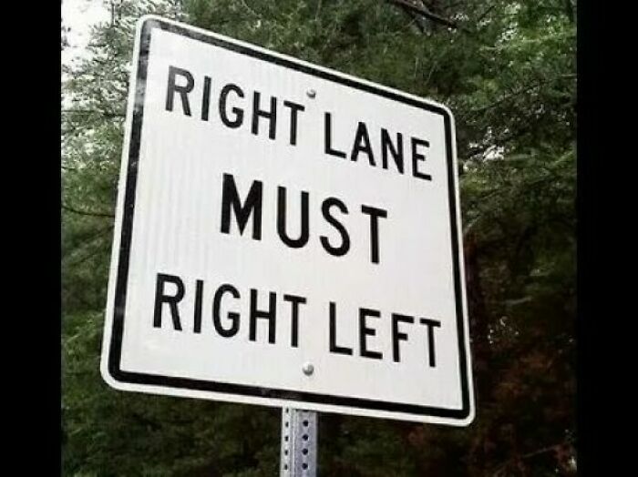 Confusing road sign showing contradictory directions in the right lane, a funny stupid signs pic on a wooded roadside.