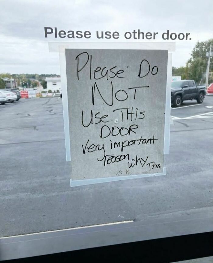 Handwritten funny stupid sign on a door saying not to use it for a very important reason with no explanation.