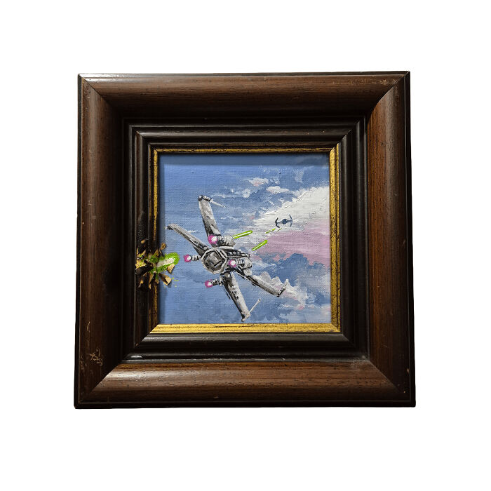 Framed thrifted painting personalized with a funny Star Wars spaceship battle added unexpectedly in the sky.