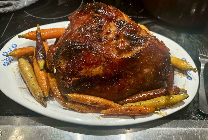 Roasted holiday turkey with glazed carrots on a white platter, showcasing festive moments and seasonal flavors.