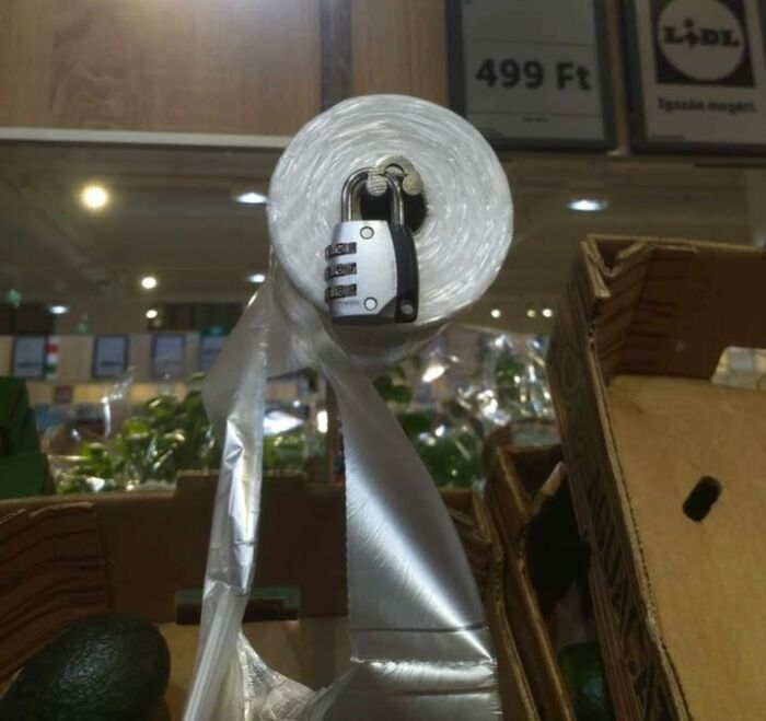 Roll of plastic wrap locked with a combination padlock in a store, illustrating Eastern Europe humor and memes.