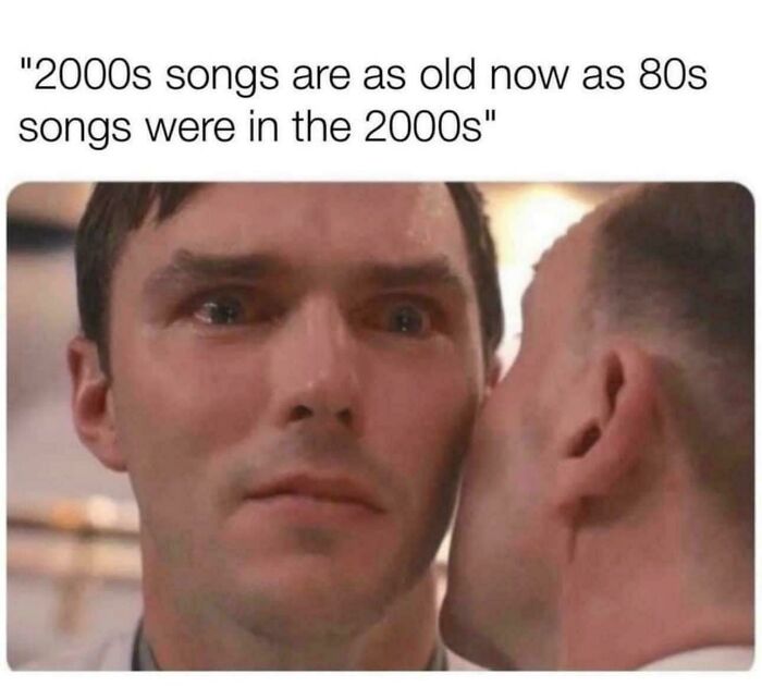 Man with shocked expression listening closely to another person, reflecting on 90s and 2000s nostalgia about old songs.