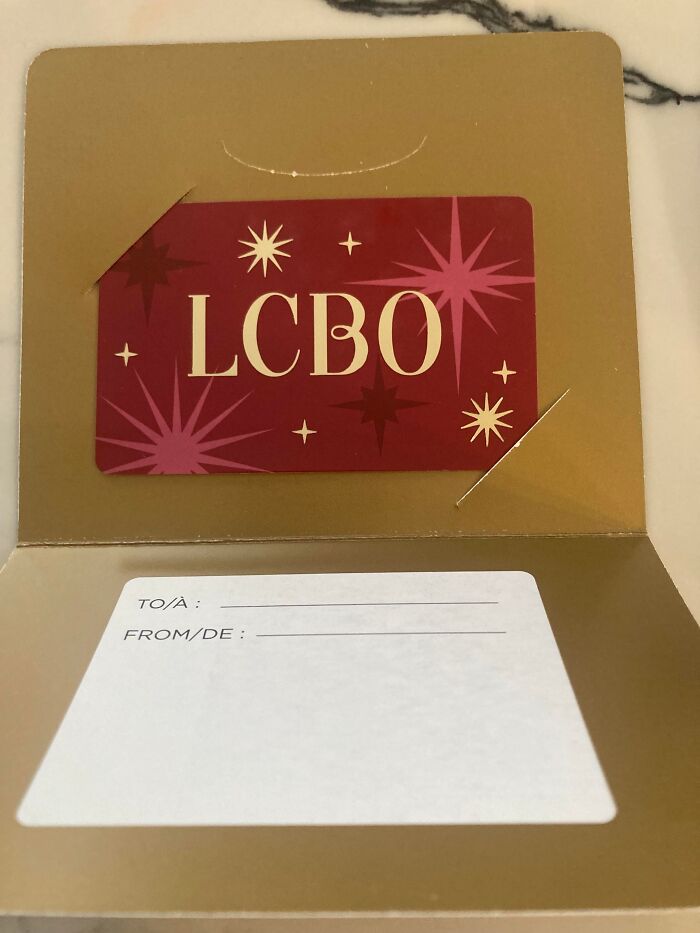 Gift card inside a gold envelope with empty To and From sections, an example of hilariously bad Secret Santa gifts.