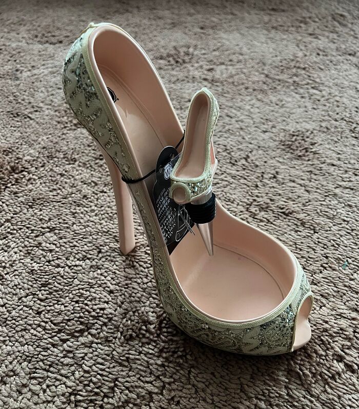 High heel shoe-shaped wine bottle holder with a stopper, one of the hilariously bad Secret Santa gifts received.