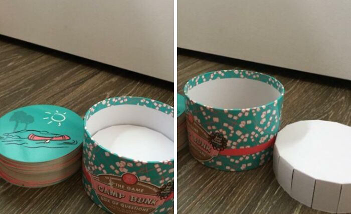 Round Camp Bunk box with a silly game of questions cards, shown as a hilariously bad Secret Santa gift on wood floor.