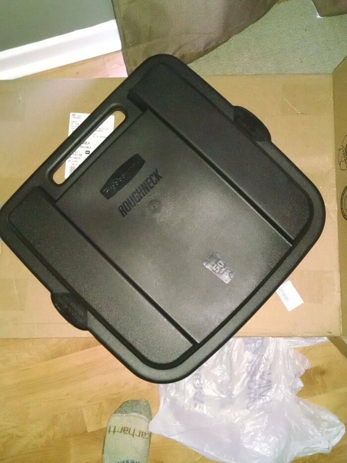 Black plastic storage container with handles, an example of hilariously bad Secret Santa gifts received.