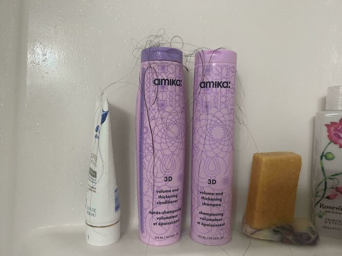 Bathroom shelf with hair care products tangled in hair, showing signs of entitled person habits in 2025 trends.