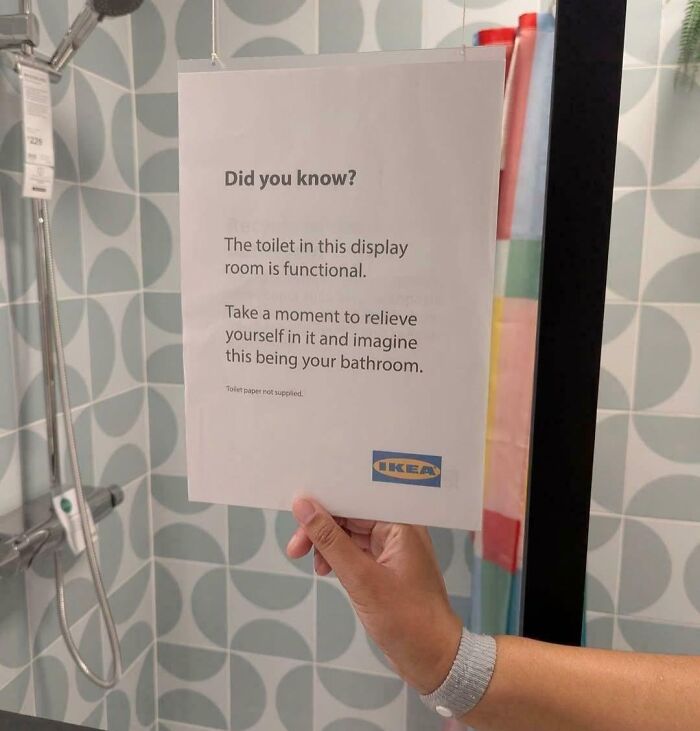 Sign in an IKEA bathroom display explaining the functional toilet encourages visitors to imagine using it, funny pictures 2025.