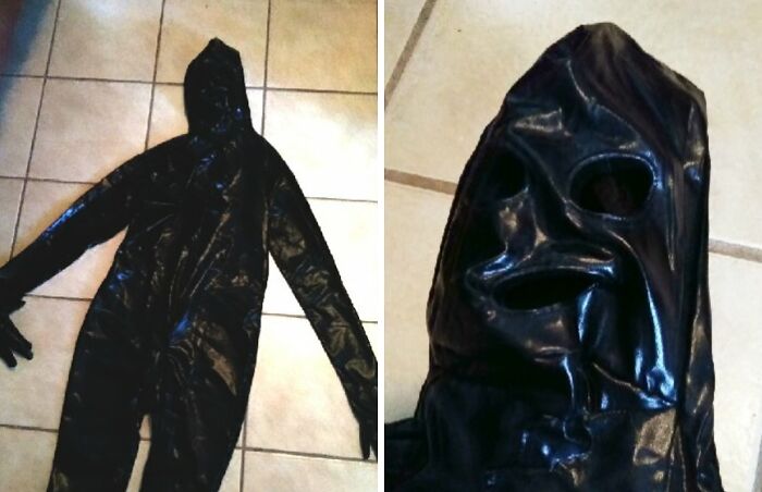 Black shiny full-body suit with hood and eye holes laid on tiled floor, an example of bad Secret Santa gifts received.