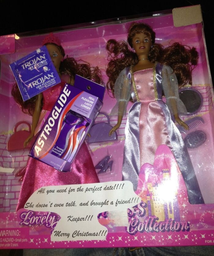 Two dolls in a pink box with condoms and lubricant, representing hilariously bad Secret Santa gifts received.