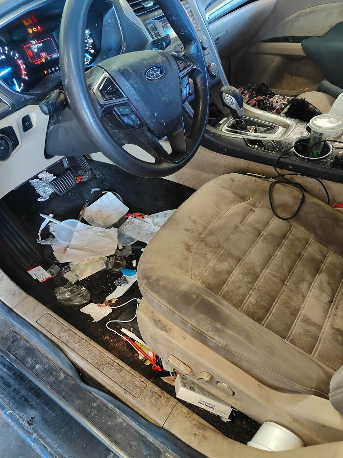 Cluttered and dirty car interior showing a messy floor and stained seat illustrating men share lessons about women.