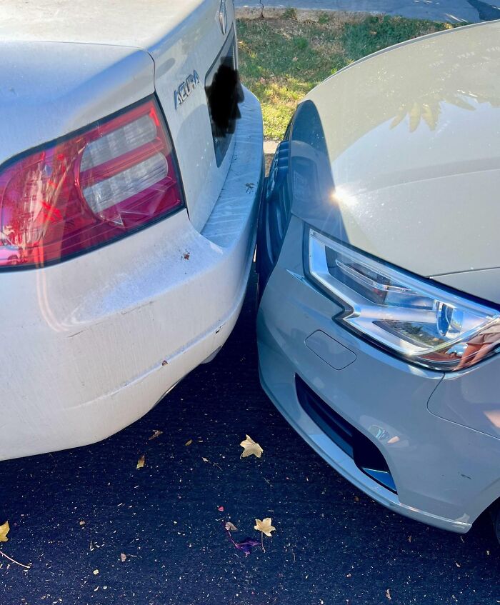 Two cars parked bumper-to-bumper with no gap, an example of next-level jerks in a parking space