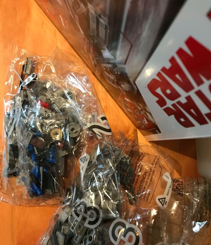 Star Wars LEGO set pieces in numbered sealed bags on a table, next-level jerks