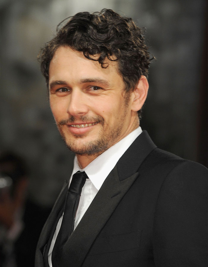 James Franco wearing a black suit and tie, smiling and attending a formal event, related to Hollywood career insights.