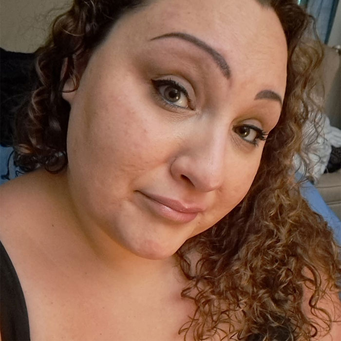 Close-up of a woman with curly hair and makeup, associated with two teens charged with homicide after brutal attack.