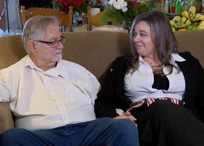 An older man and woman sitting together on a couch, sharing a heartfelt moment related to child kidnapped case. An older man and woman sitting together on a couch, sharing a heartfelt moment related to child kidnapped case.