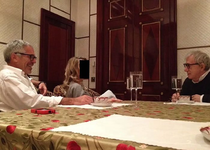 Men and woman seated around a table in a room, related to disturbing Epstein desk photo released by Congress estate images