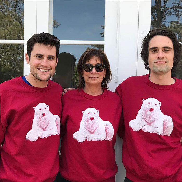 Three people wearing matching red sweatshirts with polar bear prints, related to Rob Reiner’s son arrested news. Three people wearing matching red sweatshirts with polar bear prints, related to Rob Reiner’s son arrested news.