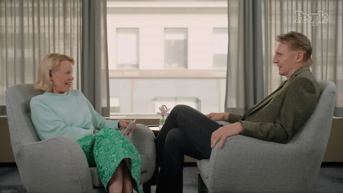Two people having a relaxed conversation in armchairs during an interview about celebrities people think suffer.