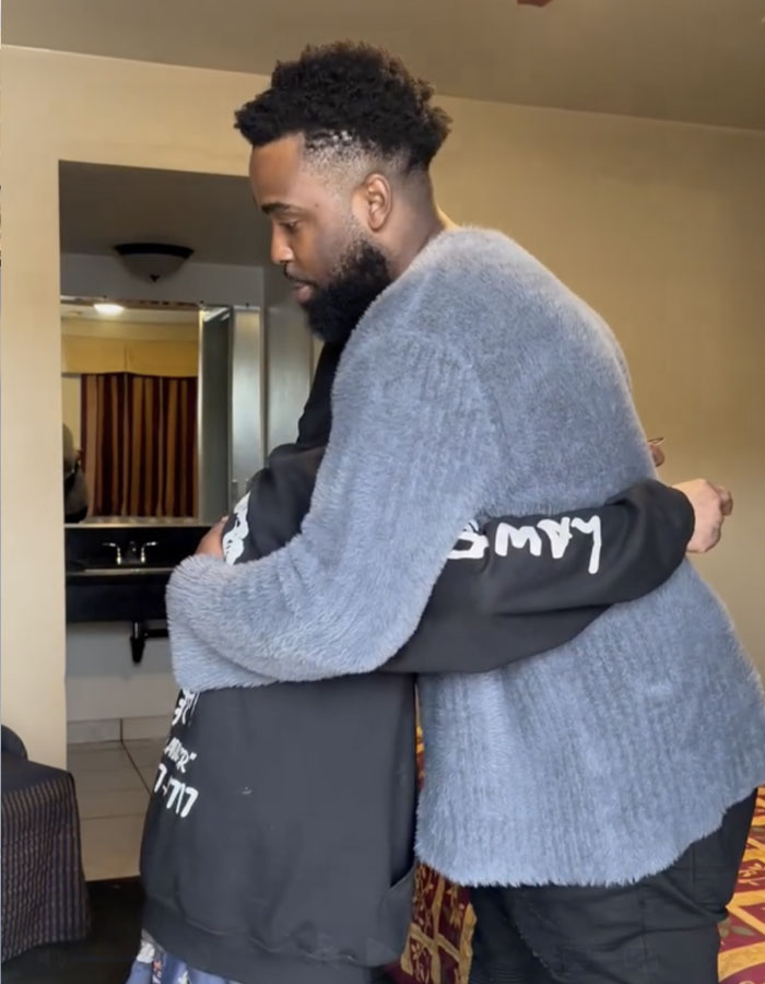 Man hugging another person indoors, illustrating the dad of Nickelodeon star Tylor Chase with a sad health update and life struggles. Man hugging another person indoors, illustrating the dad of Nickelodeon star Tylor Chase with a sad health update and life struggles.