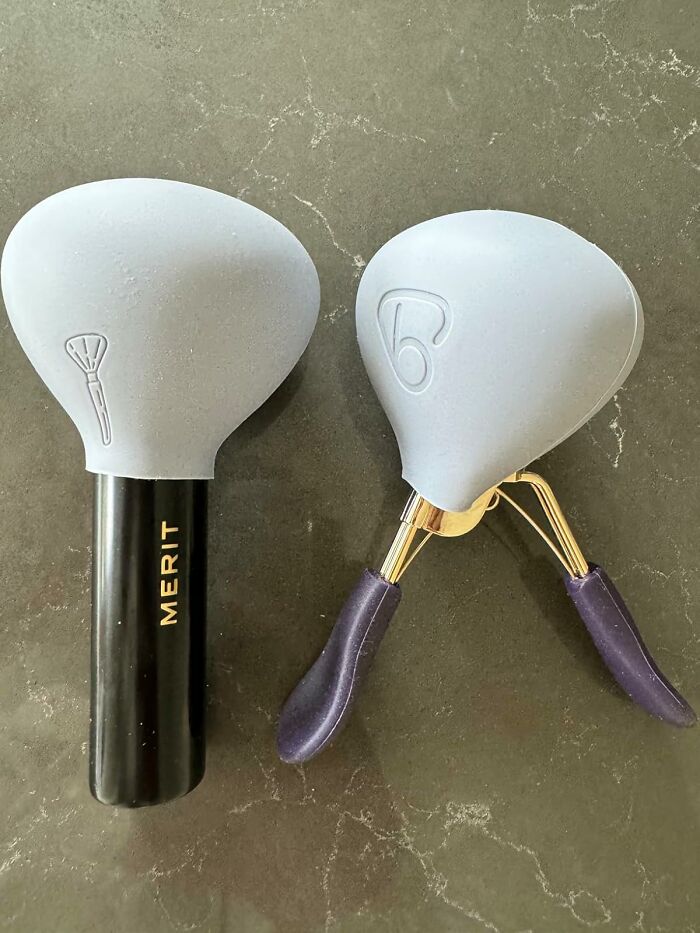 Makeup brush and eyelash curler with gray silicone covers, representing popular best sellers in 2025 trends.