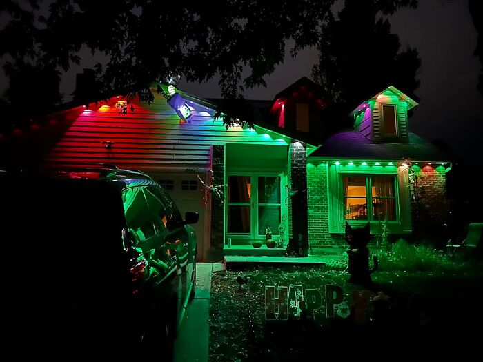 House decorated with colorful outdoor LED lights at night, showcasing popular Amazon wish list products for home decor.