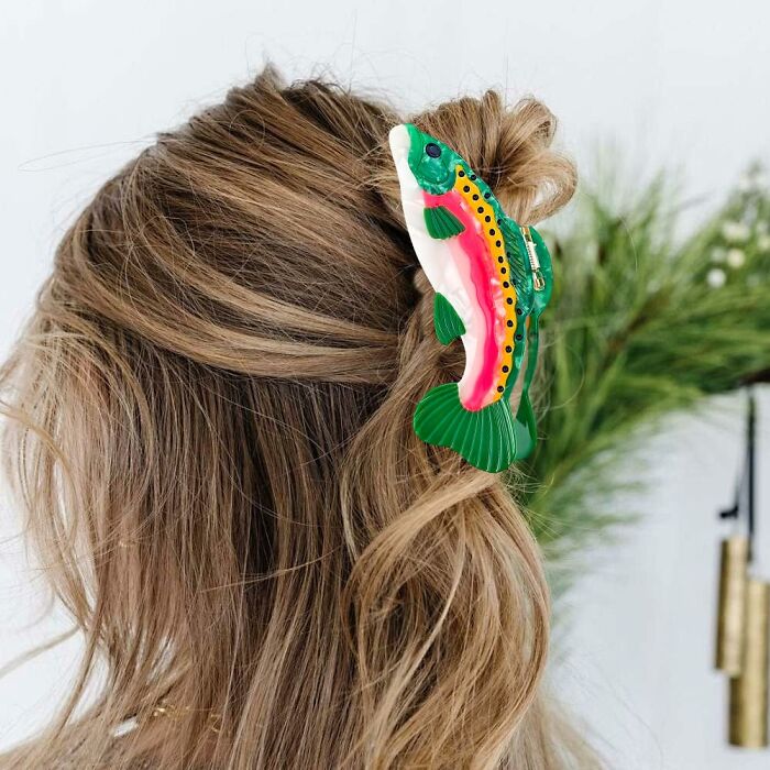 Woman with light brown hair wearing a colorful fish-shaped hair clip, showcasing unique never-before-seen gifts idea.