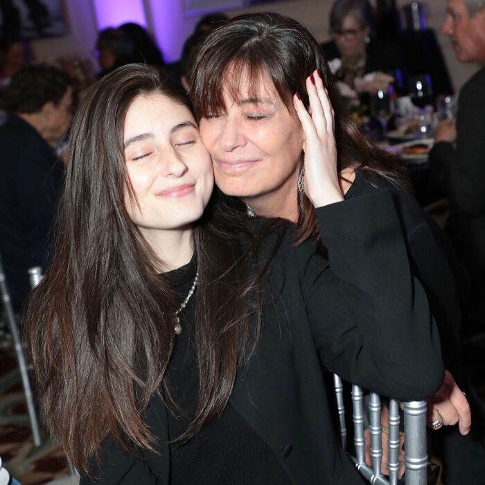 Romy Reiner looking content with her mother at an event, highlighting new details about being scared of brother Nick since childhood.