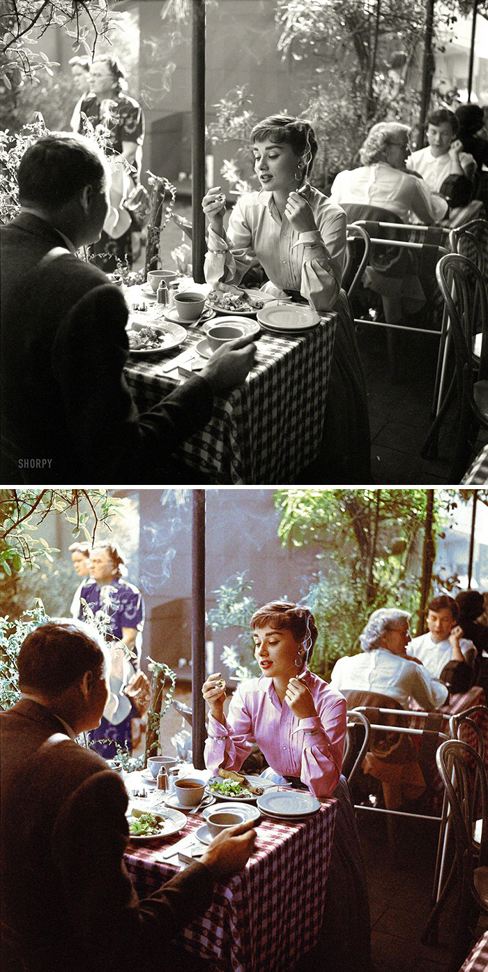 Couple dining at a restaurant with colorized old photos showing the contrast between black and white and vibrant historical scenes.