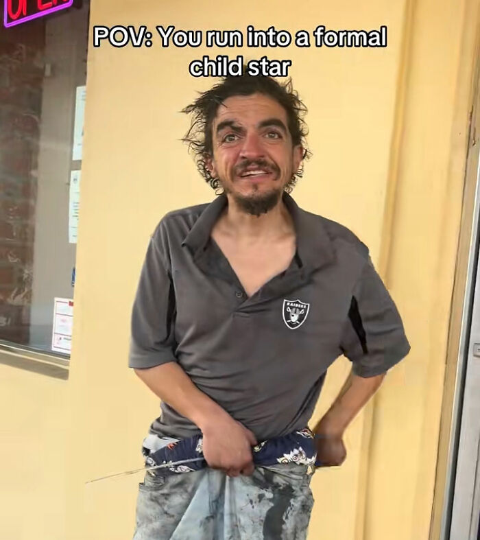 Homeless man wearing worn clothes outside building, highlighting heartbreaking Nickelodeon star struggle with homelessness. Homeless man wearing worn clothes outside building, highlighting heartbreaking Nickelodeon star struggle with homelessness.