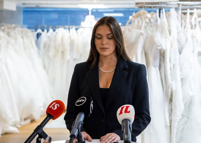 Miss Finland at a press conference in a black suit, addressing the racist gesture backlash and losing her crown controversy. Miss Finland at a press conference in a black suit, addressing the racist gesture backlash and losing her crown controversy.