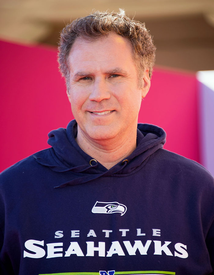 Actor wearing a Seattle Seahawks hoodie, smiling at an event showcasing outrageous demands actors included in contracts