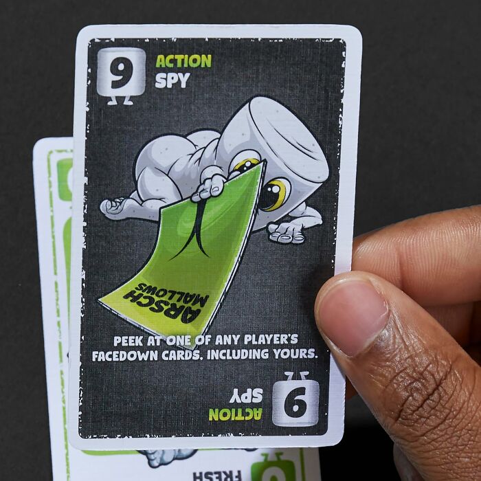 Hand holding an action spy card from a game, a creative gift idea for last-minute guests during holidays.