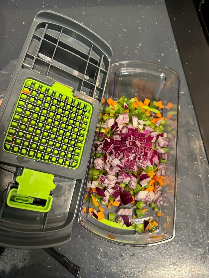Vegetable chopper with diced onions, carrots, and green peppers on a countertop, popular Amazon product.