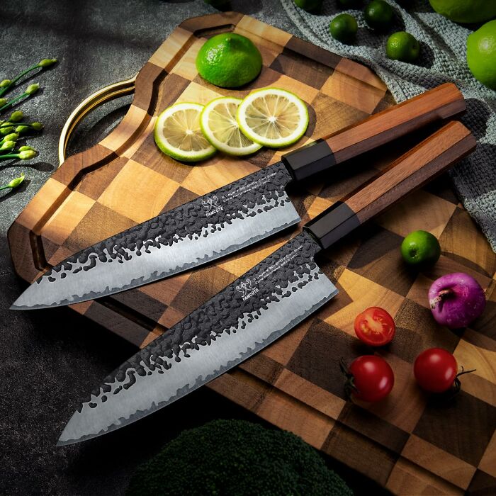 Set of premium kitchen knives on a wooden cutting board with fresh vegetables, ideal gifts for a mother-in-law.