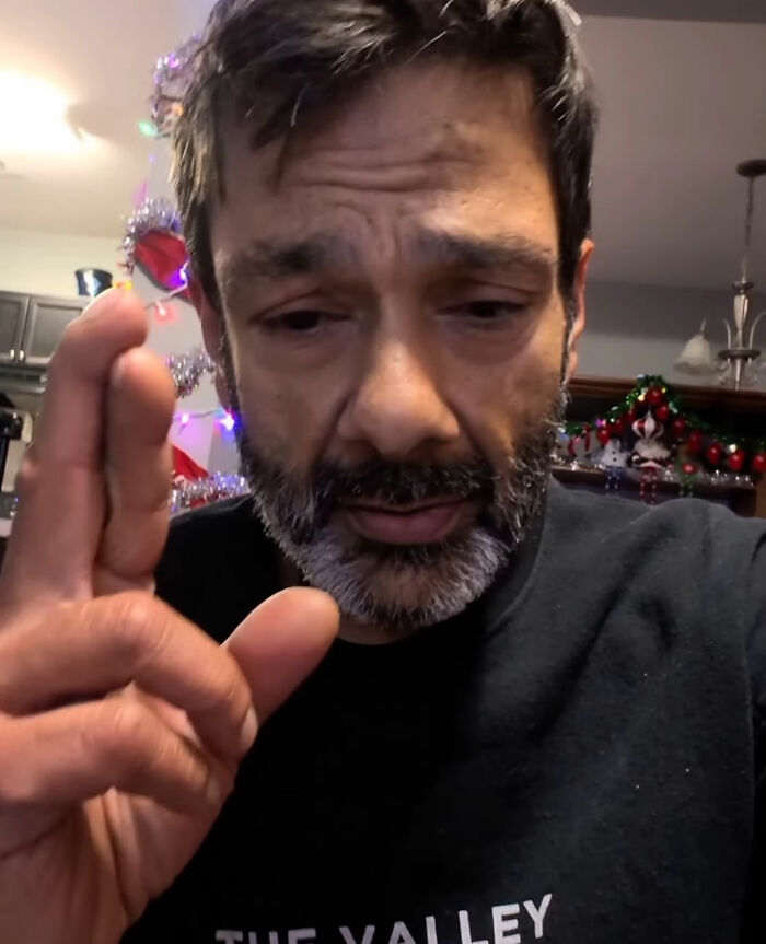 Man with a beard and serious expression raising hand, relating to Tylor Chase’s hospitalization and friend’s revelation. Man with a beard and serious expression raising hand, relating to Tylor Chase’s hospitalization and friend’s revelation.