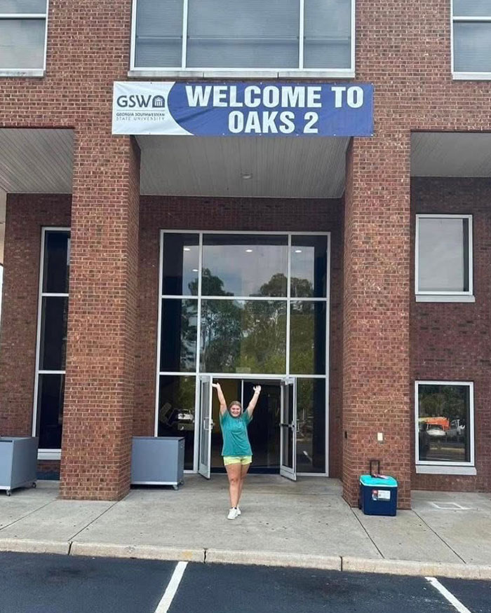 Young woman standing outside a building, unrelated to the beauty queen accused of toddler’s passing appearing in court.