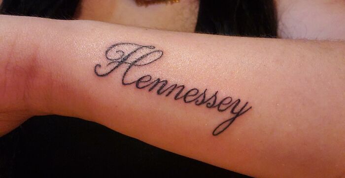 Tattoo of a name on forearm, representing one of the crazy things people have done to make their ex pine for them.