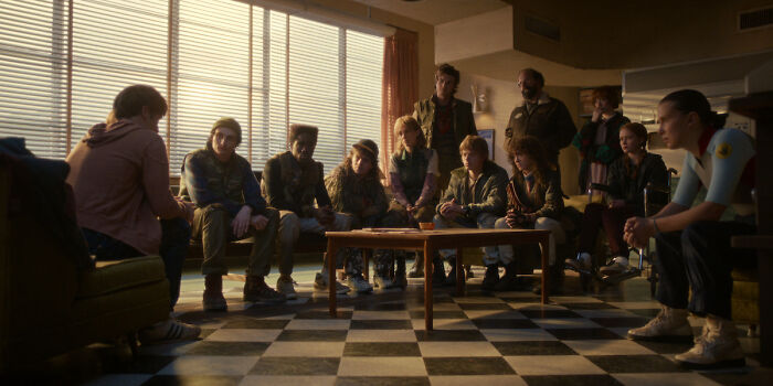 Cast of Stranger Things 5 sitting in dimly lit room, reflecting tense moments after a comically bad and cringe penultimate episode.