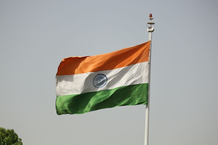 Indian flag waving against clear sky symbolizing tragic wedding event uncovering aunt's disturbing pattern after missing child's body found