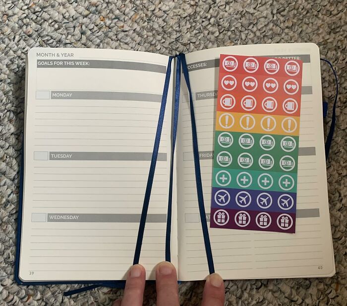 Open weekly planner with colored sticker sheet displaying icons, a creative gift idea for the person who has everything.