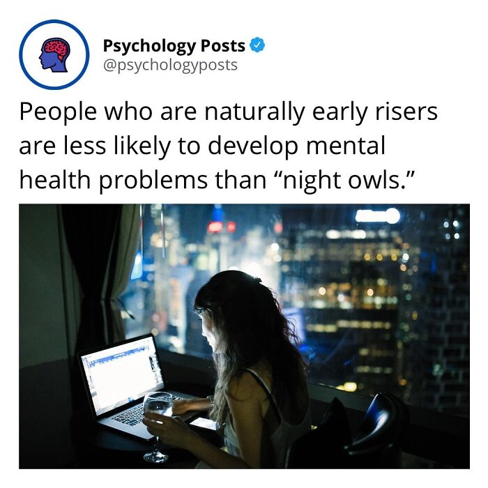 Person working on laptop at night with a drink, illustrating psychology facts about early risers and mental health risks.