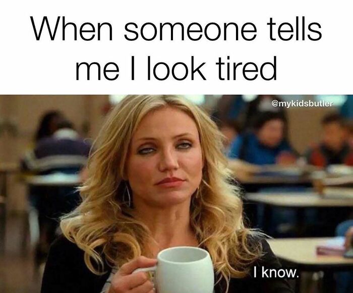 Woman holding a coffee mug with exhausted expression, illustrating funny and savage parenting memes about tiredness.