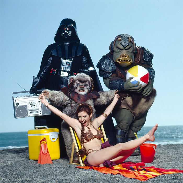 Rarely-seen pop culture moment with Star Wars characters at the beach, featuring Darth Vader and Princess Leia in a playful scene.
